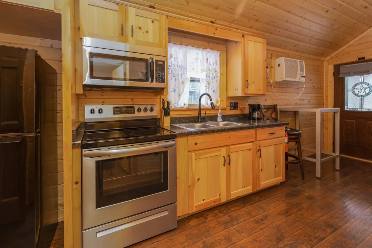 Cabin #11 at Al's Hideaway — full kitchen with stainless steel appliances
