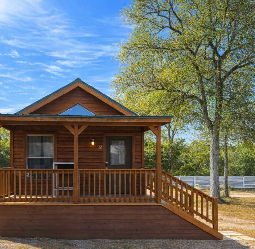 Cabin #12 at Al's Hideaway — log cabin exterior with covered porch