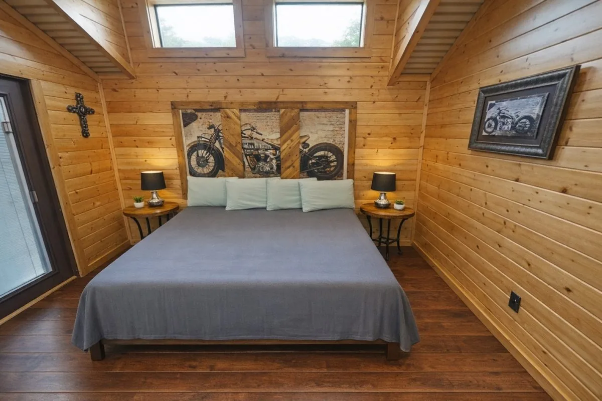 Cabin #4 at Al's Hideaway — rustic bedroom with motorcycle art headboard
