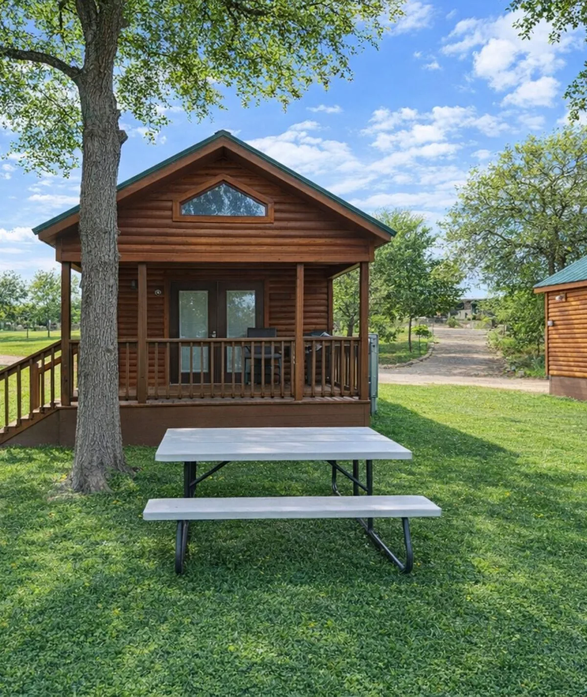 Cabin #6 at Al's Hideaway — log cabin exterior with covered porch and picnic table